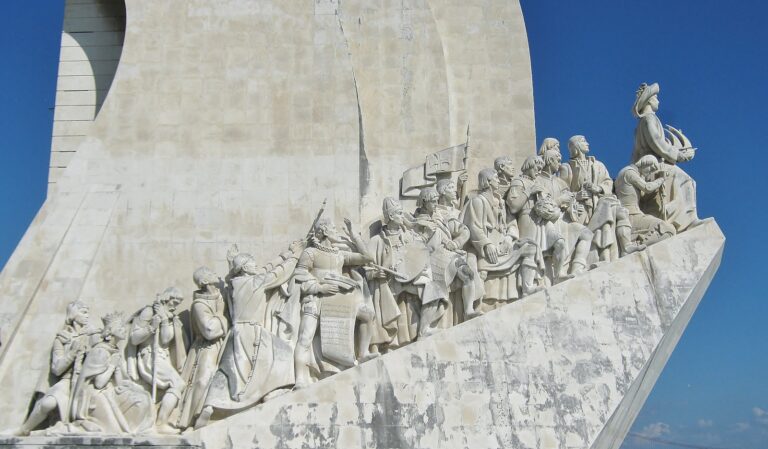 gray concrete statues on white concrete wall